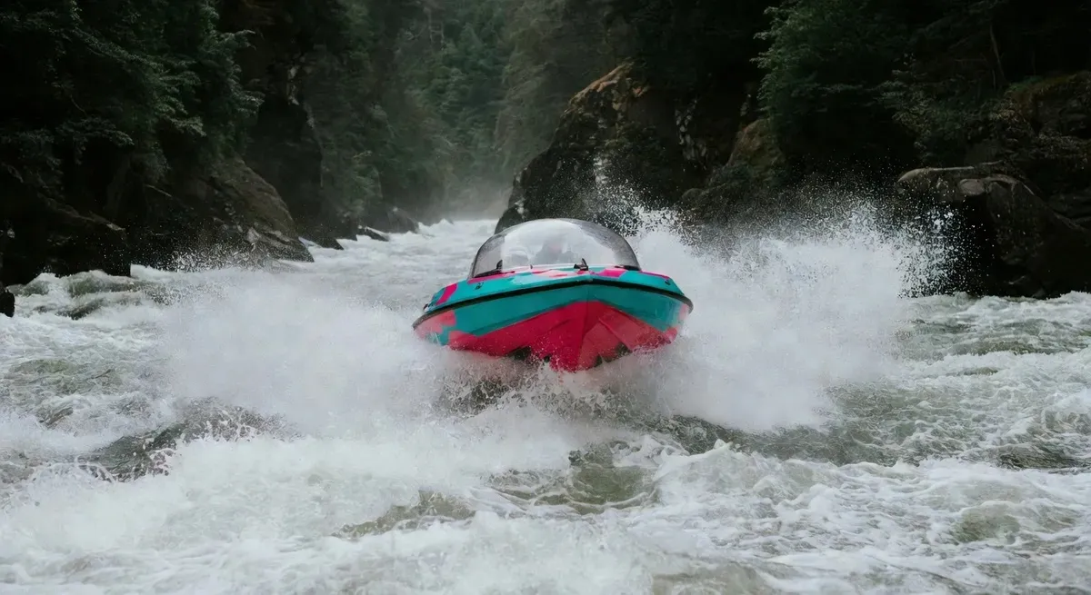 The Whirlpool Jet domed boat crashing through Niagara Gorge rapids on a Niagara Falls jet boat and sightseeing combo tour from the USA side